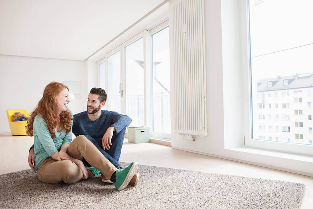 couple sitting on the floor of their new home