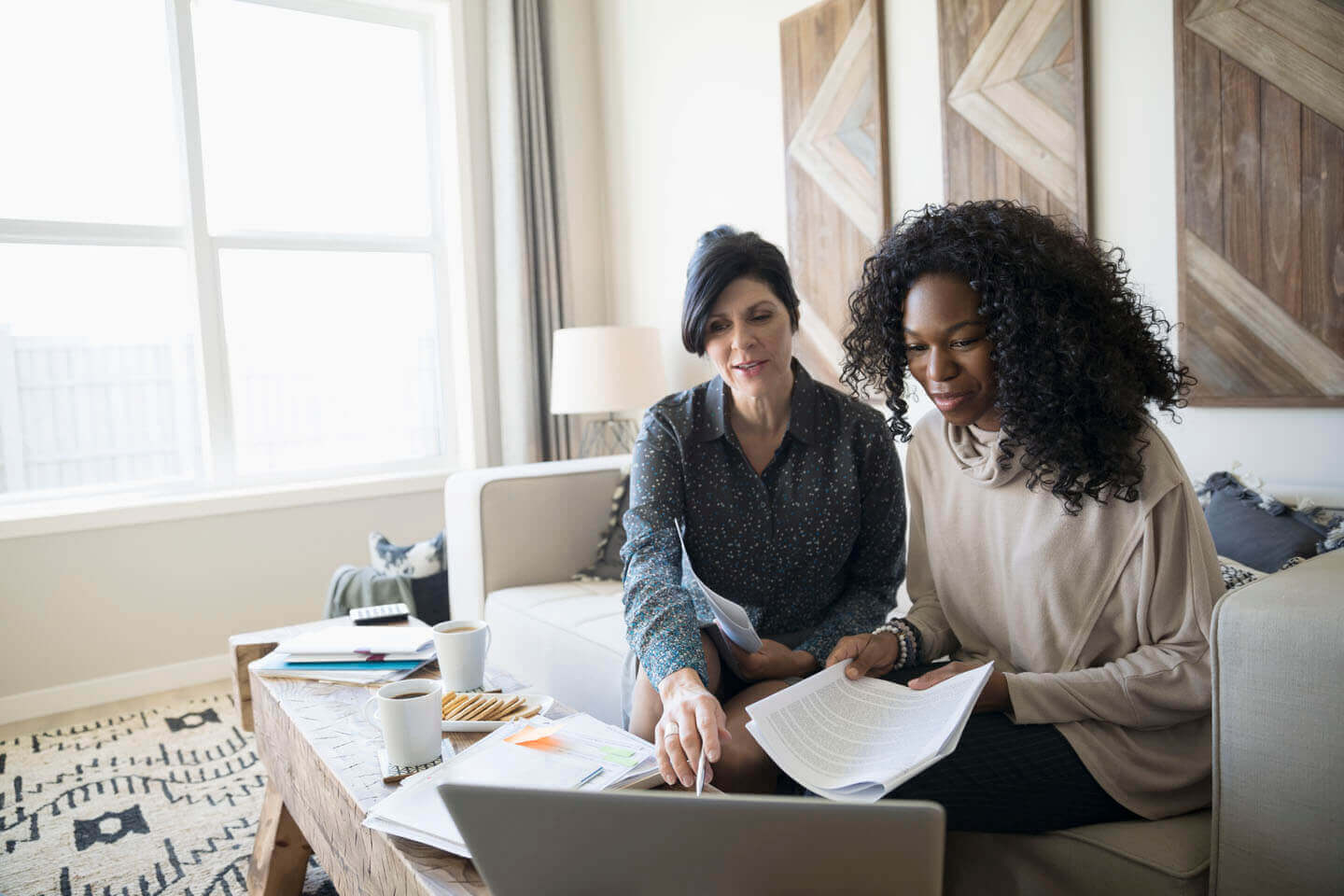 A advisor supporting a customer at home with legal documentation