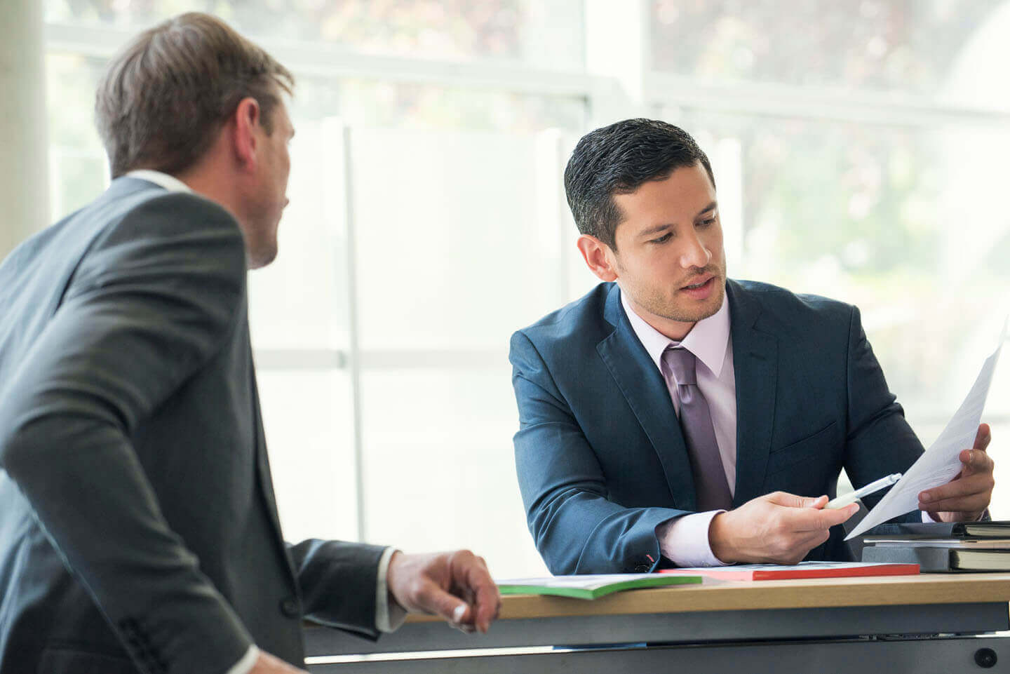 Two legal advisors reviewing a document