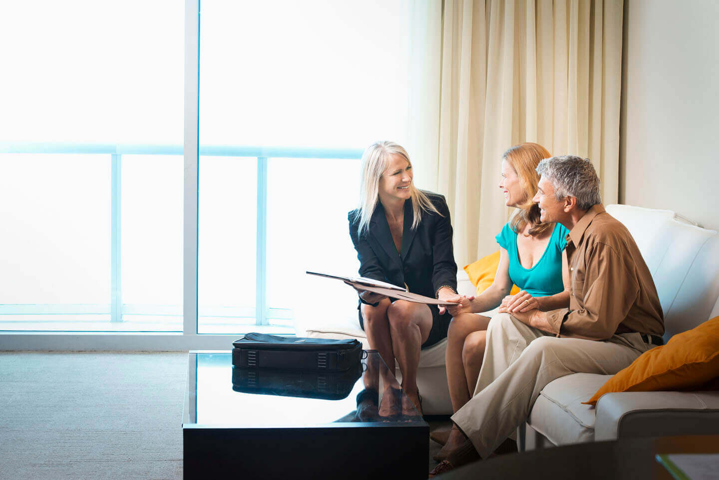 A friendly solicitor discussing paperwork with a couple