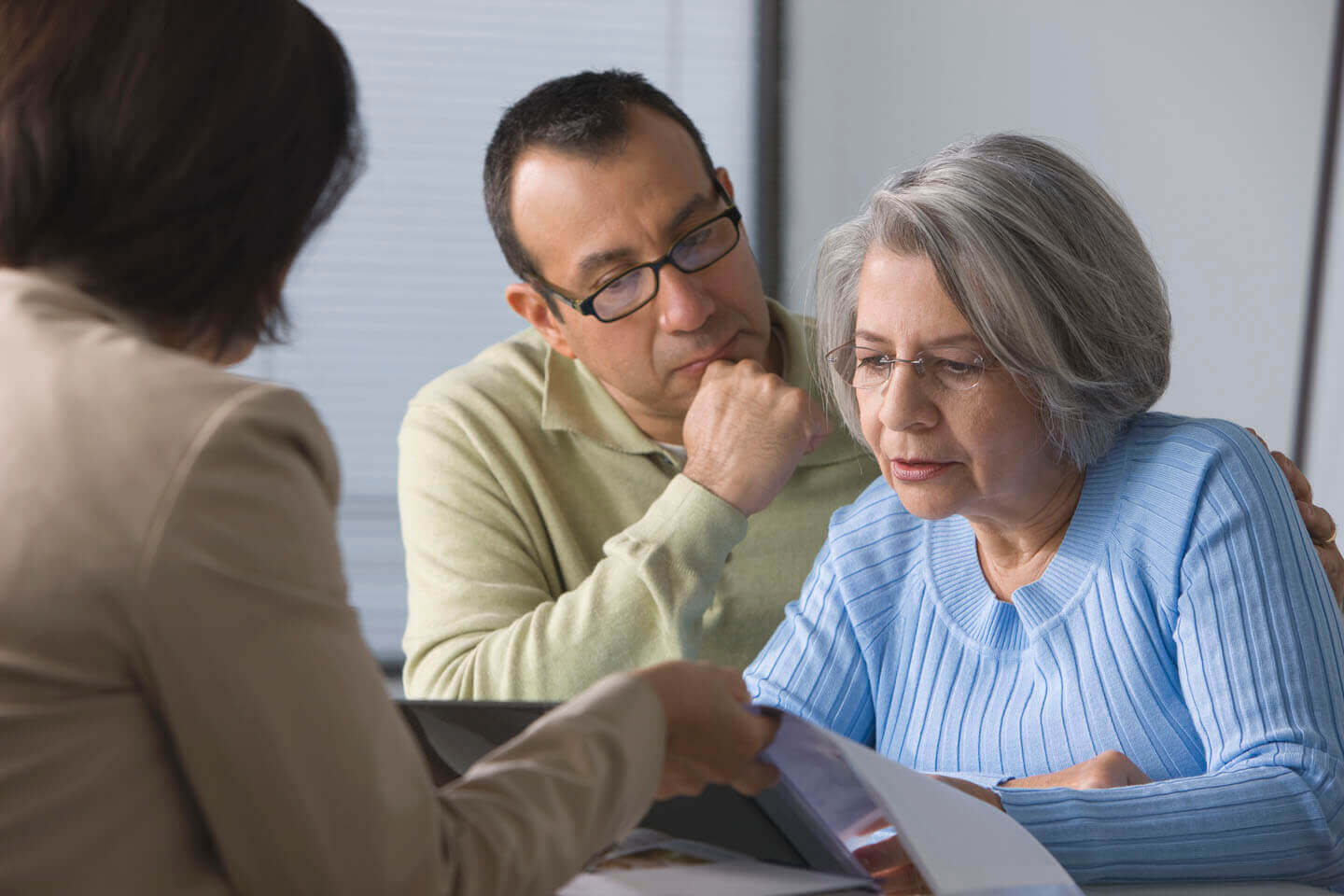 A senior woman and son signing a contract