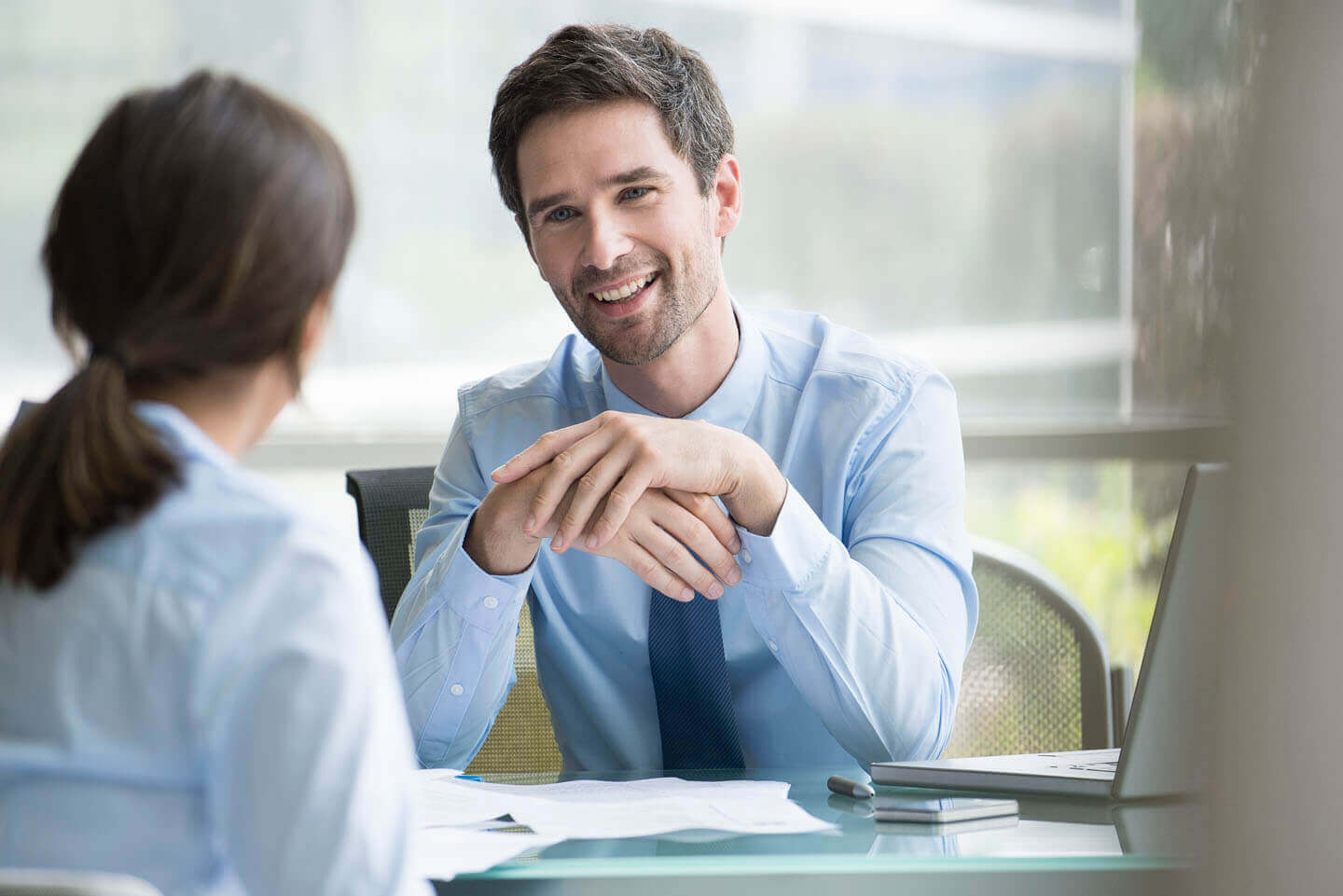 Two solicitors at a desk discussing documentation