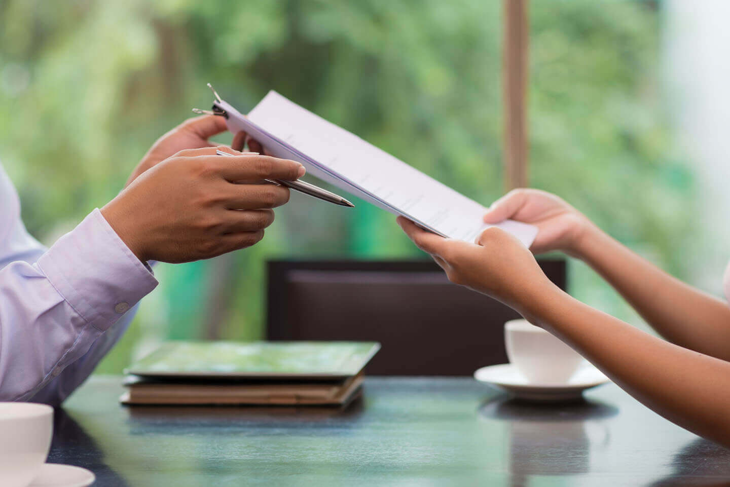 A document being handed over in a meeting