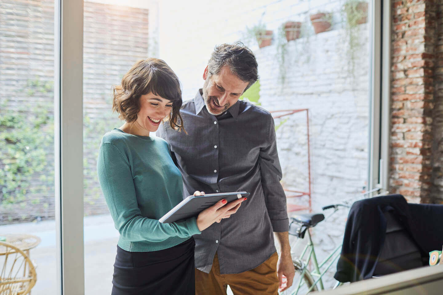 A couple reviewing documentation via a tablet