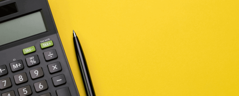calcualtor and pen against a yellow background