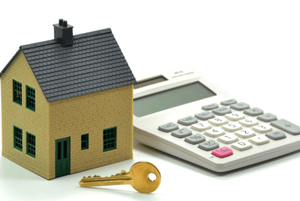 a model house, key and calculator