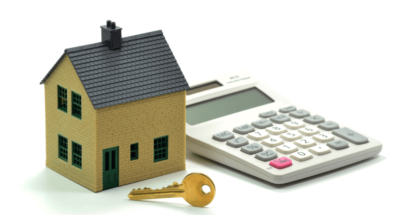 a model house, key and calculator