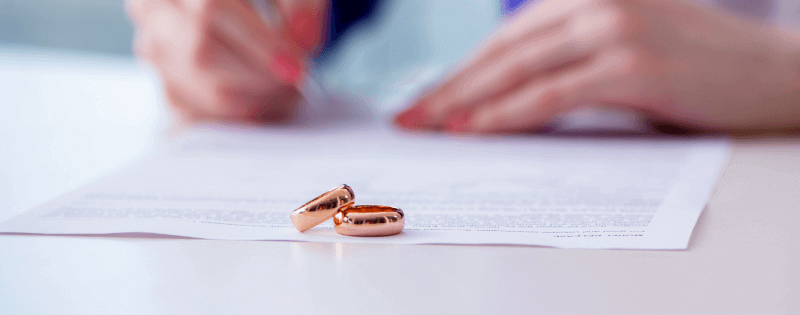 woman signing a prenup