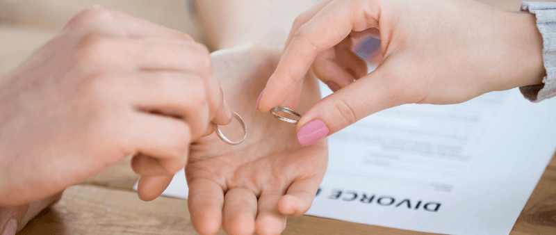 couple handing over their wedding rings in a divorce