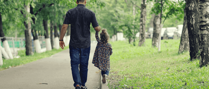 single parent walking a child